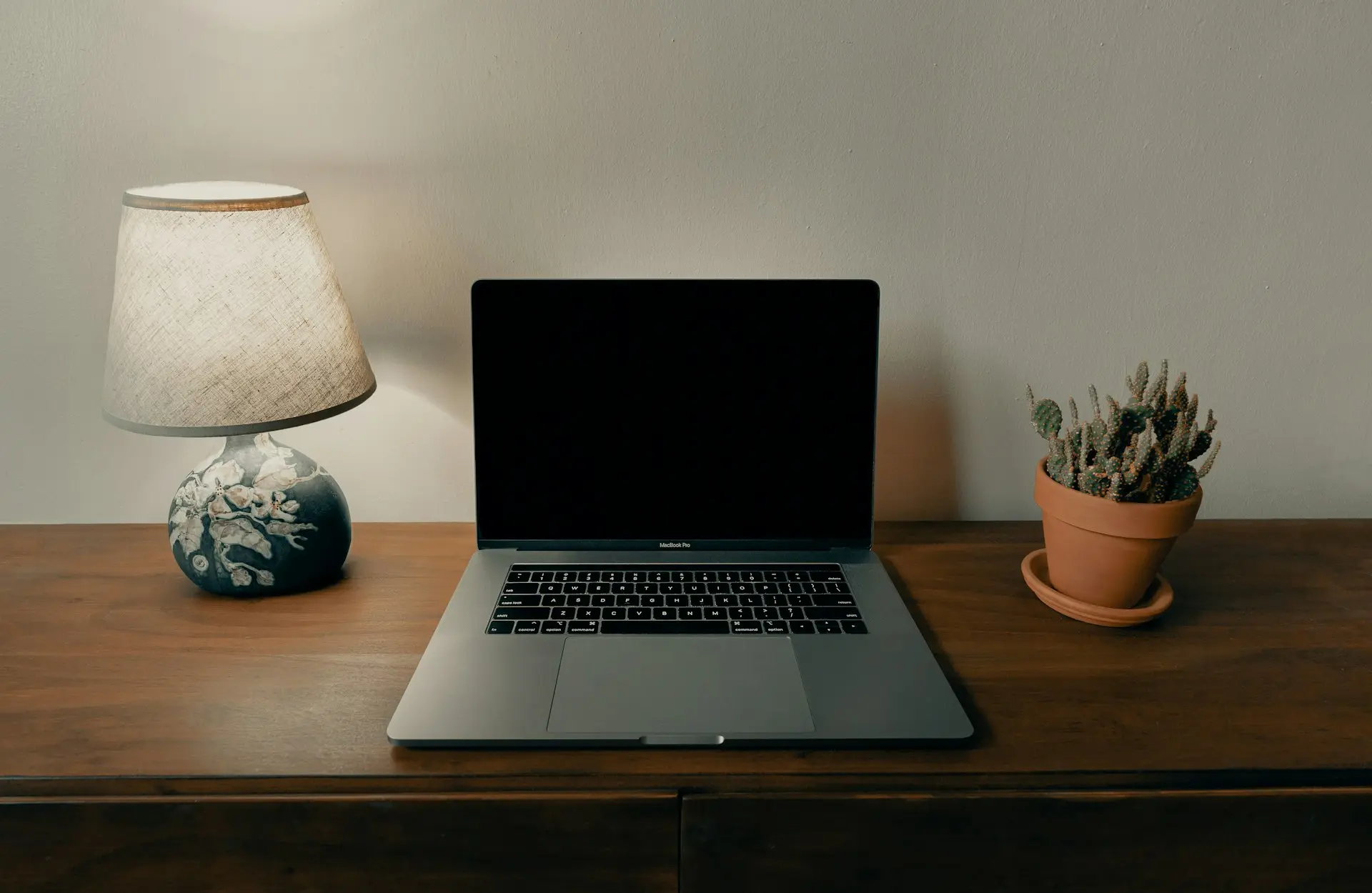 macbook pro on brown wooden table
